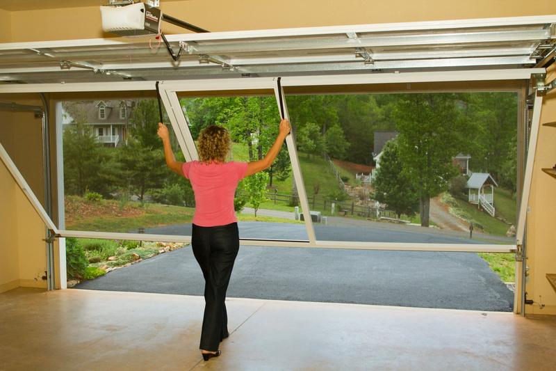 Lifestyle retractable screen installed on a two-car garage